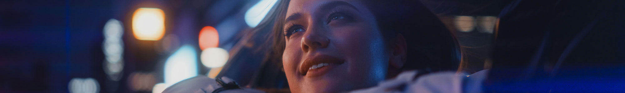 Woman looking out of car window at night